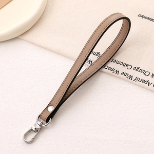 Close-up of brown PU leather hand strap with silver swivel lobster clasp and stitching