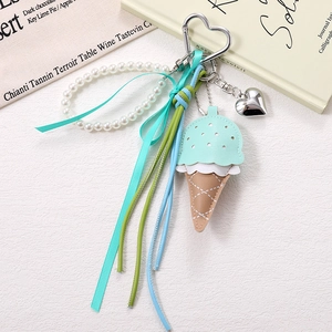 Detail of ice cream PU leather keychain with white pearls, mint ribbon and heart clasp
