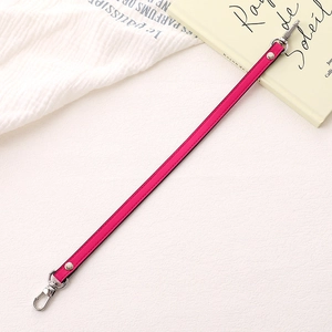 Close-up of rose pink PU leather strap with silver lobster clasps and metal rivets