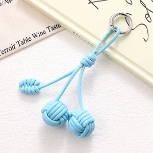 Close-up of light blue leather woven knot phone charm with silver metal ring buckle