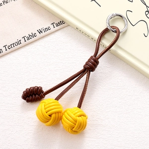 Handmade woven PU leather phone charm with yellow dual balls and silver metal ring
