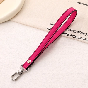 Close-up of magenta PU leather wrist strap with silver metal lobster clasp and rivets