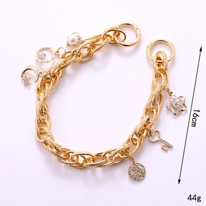 Gold chunky chain bracelet with pearl, star, and moon charms, 16cm length and 44g weight