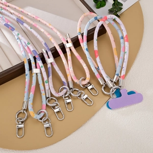 Detailed view of colorful PU leather phone lanyards with floral patterns and metal clips