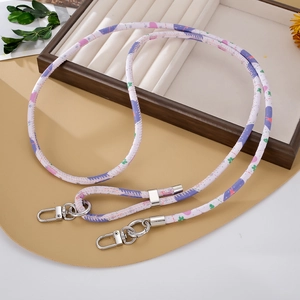 Detail of PU leather phone strap with purple heart patterns and silver metal clasps