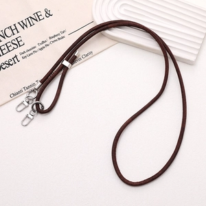 Detail of dark brown braided neck strap with silver metal lobster clasps and slider