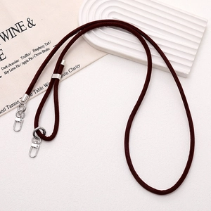 Detail of burgundy adjustable flocked PU leather strap with silver metal swivel hooks