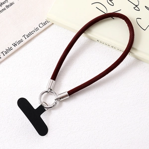 Detail of burgundy woven leather wrist strap with silver metal ring and black pad