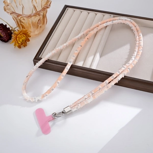 Close-up of pink sequined denim phone lanyard with silver metal clasp on a white surface