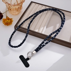 Detail of dark blue denim woven phone lanyard with silver sequins and metal buckle