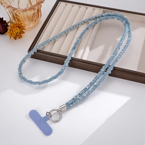 Close-up of light blue sequined denim phone lanyard with silver ring and purple pad