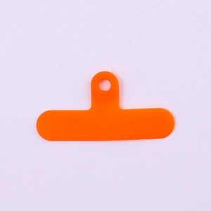 Close-up of orange PVC phone lanyard tether tab with reinforced circular hanging hole