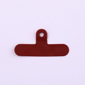 Detail view of red PVC phone tether tab connector with reinforced ring for lanyards