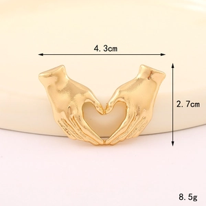 Macro shot of gold heart-shaped hand gesture charm with 4.3cm width and 2.7cm height