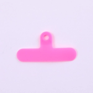 Detail of bright pink T-shaped PVC phone lanyard connector pad for universal phone cases
