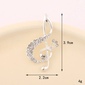 Detailed view of a silver violin brooch with clear rhinestones showing dimensions 3.9cm x 2.2cm