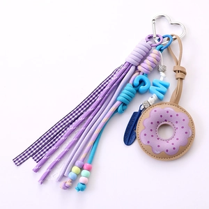 Handmade purple leather donut bag charm with heart clasp and colorful beaded fringe