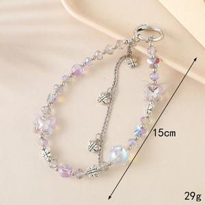 Chic iridescent beaded phone strap with metal butterfly charms on minimalist tray