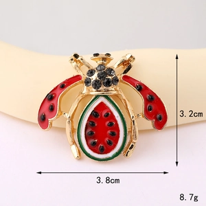 Macro view of vintage bee charm featuring watermelon enamel body and black rhinestone details