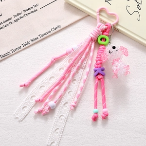 Handmade woven puppy charm with pink heart clasp and beaded poodle for bags and phones