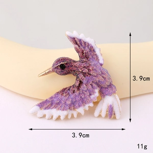 Macro shot of 3.9cm hummingbird charm with purple glitter finish and alloy base