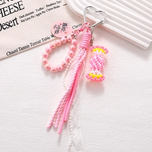 Pink handmade acrylic candy phone charm with lace, woven tassel and metal heart clip
