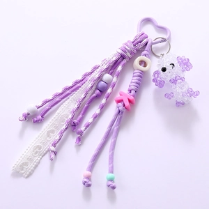 Handmade purple beaded poodle charm keychain with woven tassel and letter K accessory