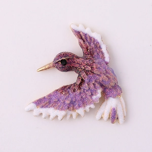 Exquisite purple and white hummingbird charm with glitter coating and golden beak detail