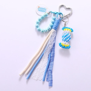 Handmade woven candy phone charm with blue beads and white lace ribbon in summer style