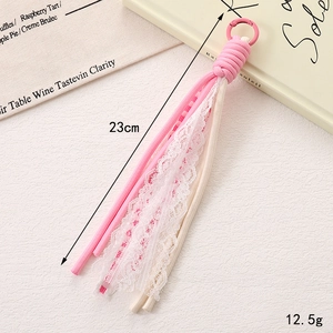 Close-up of pink and cream woven phone strap with lace detail and carabiner clip