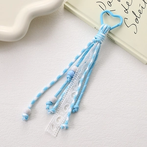 Light blue heart clasp keychain with lace ribbon and beaded charm on white background