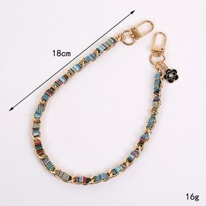 Elegant 18cm woven phone wrist strap with gold chain, fabric inlay and flower charm