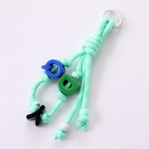 Handmade mint green woven rope phone strap with colorful alphabet beads and metal clasp