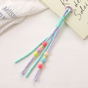 Handmade woven phone charm with mint and purple cord and colorful pastel resin beads