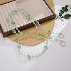 Detail of beaded star strap with green translucent stars and silver spring rings