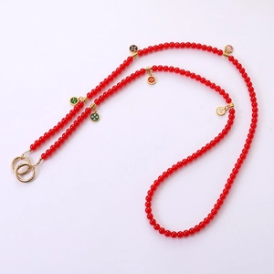 Long red glass beaded phone lanyard with decorative round charms and gold ring clasps