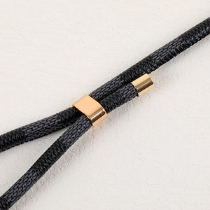 Adjustable long phone strap with black checkered leather cord and gold metal accents