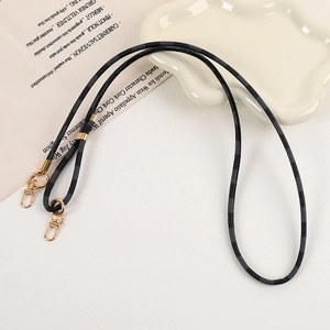 Close-up of black and grey checkered phone strap with premium gold metal hardware and hooks