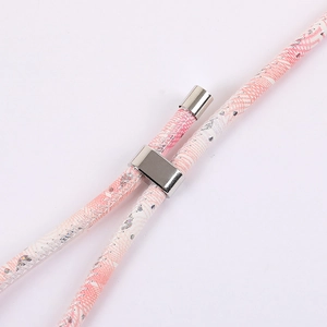 Pink and white patterned phone lanyard with silver sequins and polished metal slider