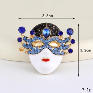 Detailed view of Venetian mask brooch with blue crystals and size markings of 3.5cm by 3.2cm