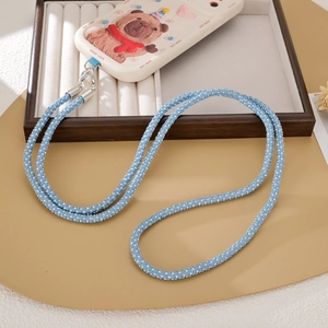 Sky blue rhinestone crossbody phone lanyard with silver metal clips on white display stand