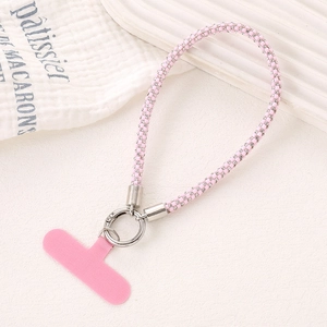 Detail of pink rhinestone wrist strap with silver metal clasp and phone connector pad