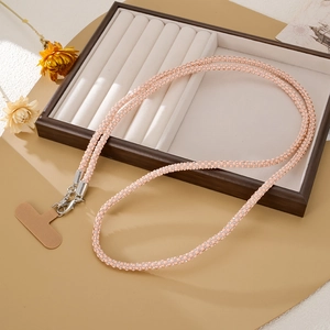 Pink rhinestone crossbody phone strap with silver spring buckles and brown connector tab