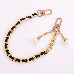 Golden metal chain strap with black leather weave and dual pearl charms for bags