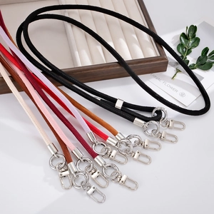 Close-up of suede crossbody phone straps in multiple colors with silver metal swivel hooks
