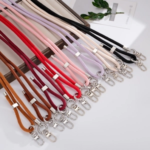 Detail view of colorful braided lanyards with silver lobster clasps and adjusters