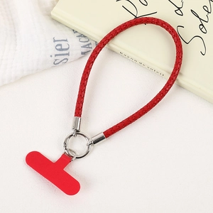 Close-up of bright red PU leather braided phone wrist strap with silver spring ring
