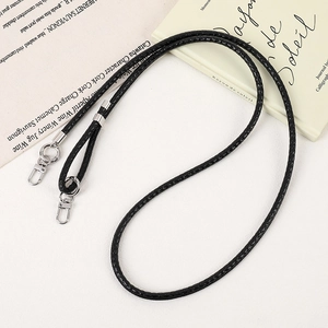 Detail of black woven PU leather phone lanyard with polished silver lobster clasp