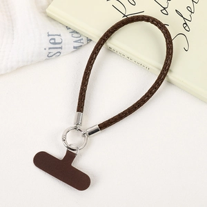 Detail of dark brown braided PU leather phone wrist strap with silver metal ring buckle
