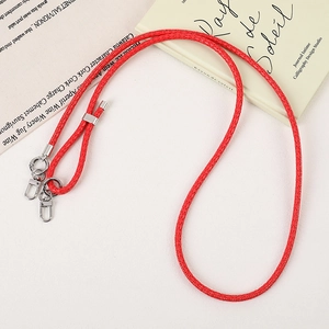 Detail of red braided PU leather phone strap with silver lobster clasps and slider buckle